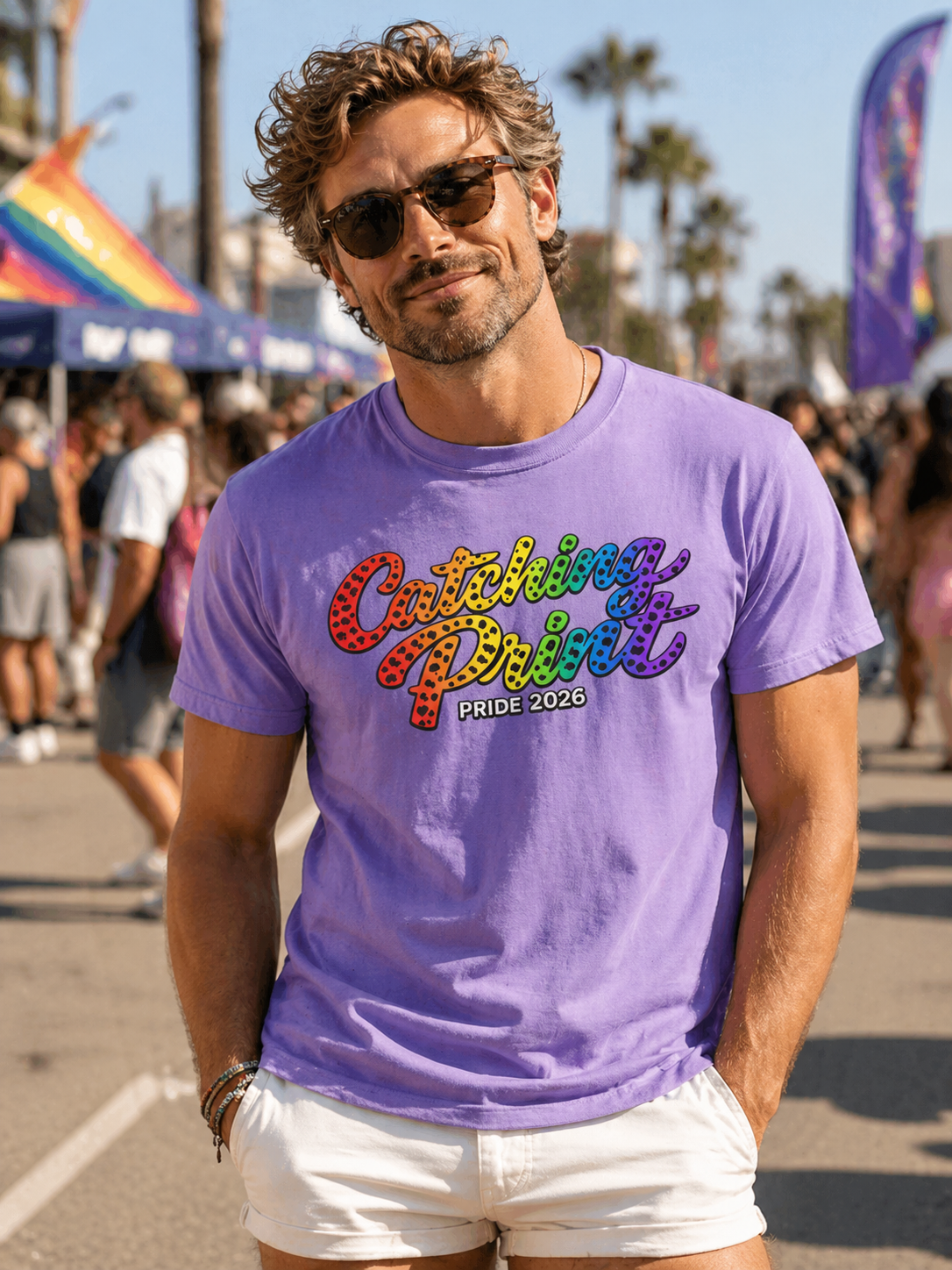 Man wearing a purple t-shirt with colorful text at a Pride event.