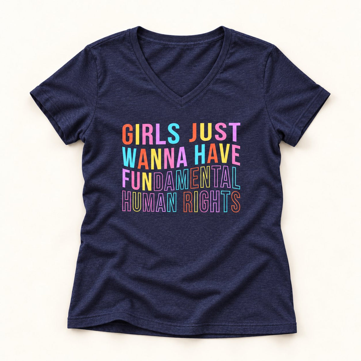 Girls Just Wanna Have Fundamental Human Rights V-Neck T-Shirt in Heather Navy, flat lay on warm off-white background