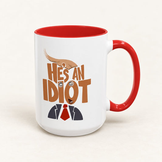 He’s an Idiot Coffee Mug, 15 oz, on a warm off-white background