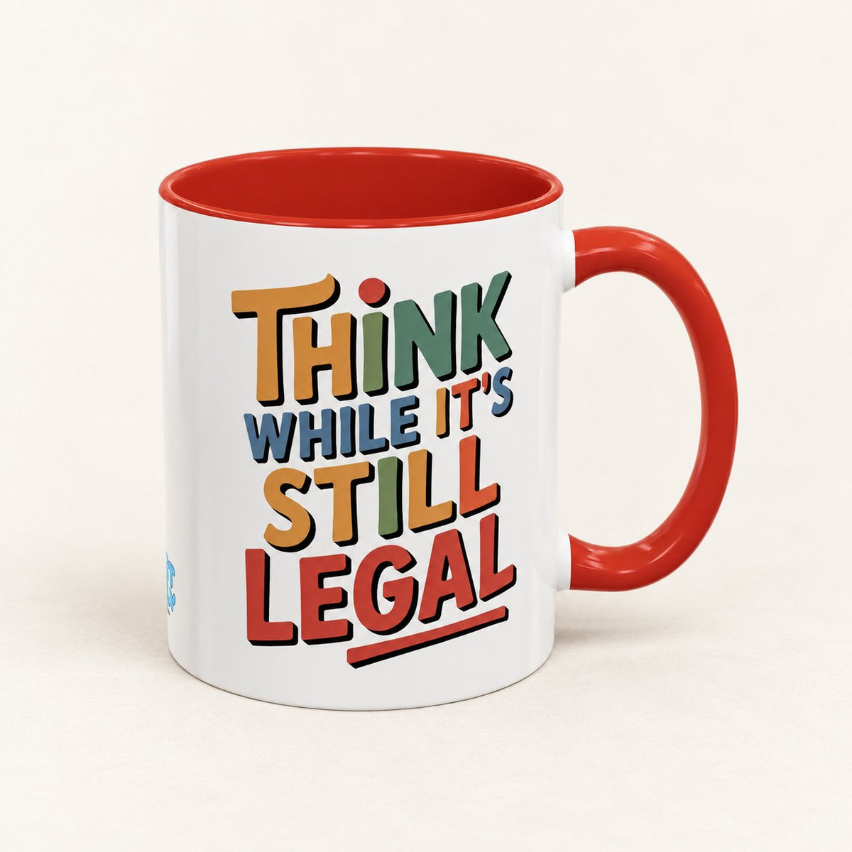 Think While It's Still Legal Coffee Mug on warm off-white background