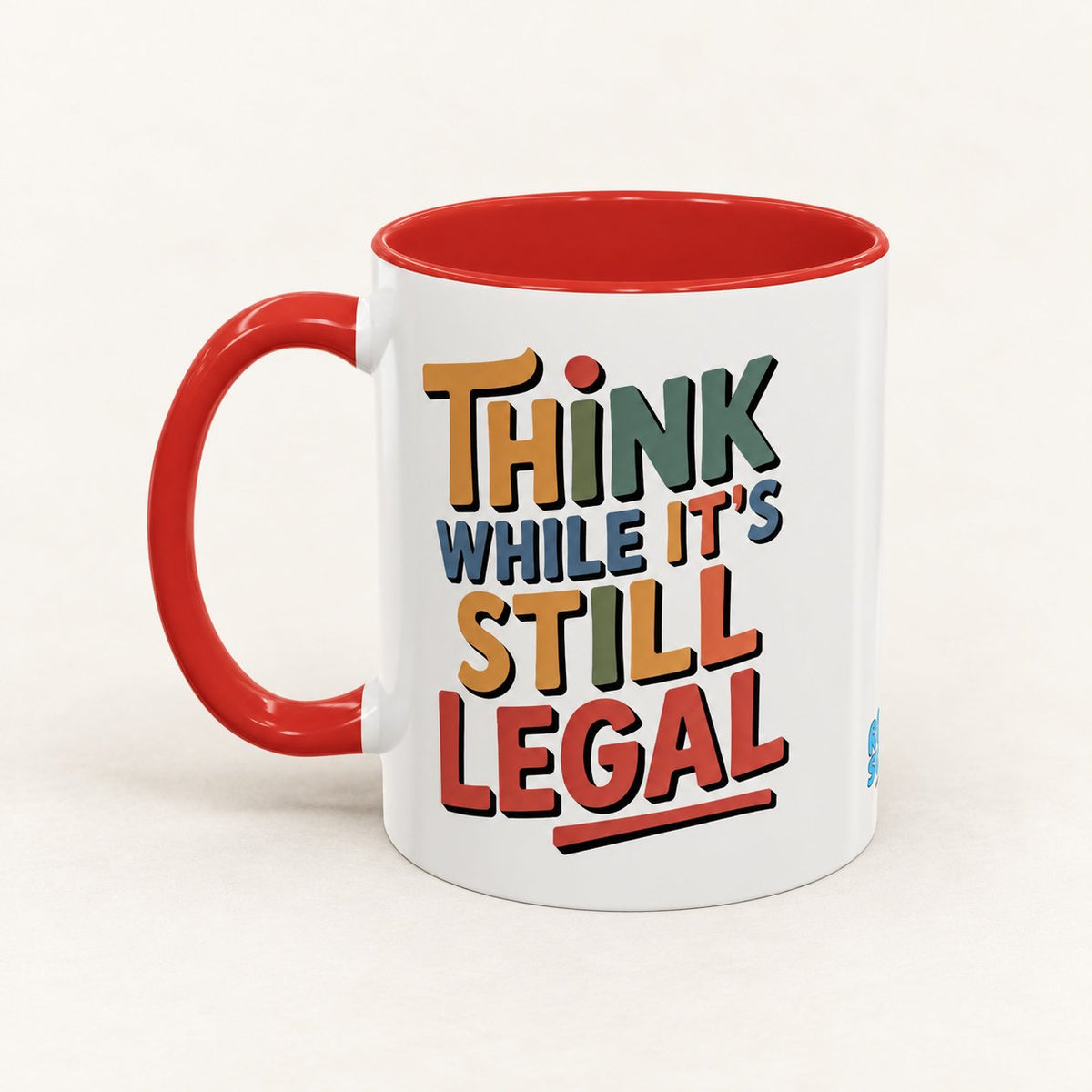 Think While It's Still Legal Coffee Mug on warm off-white background