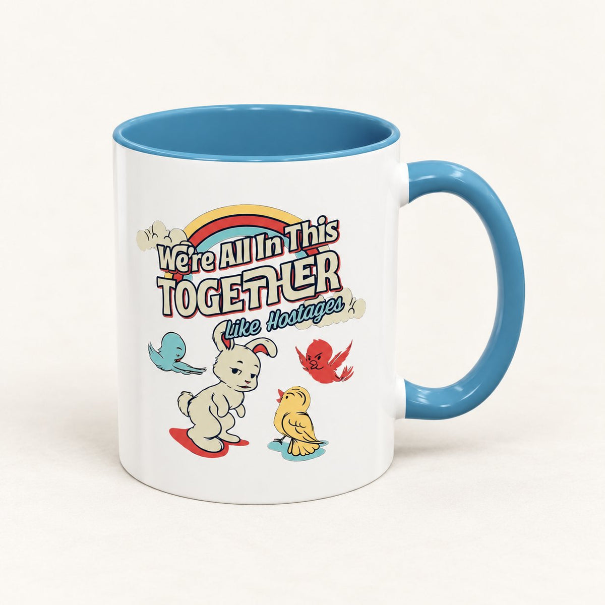 We’re All in This Together Like Hostages Coffee Mug on warm off-white background