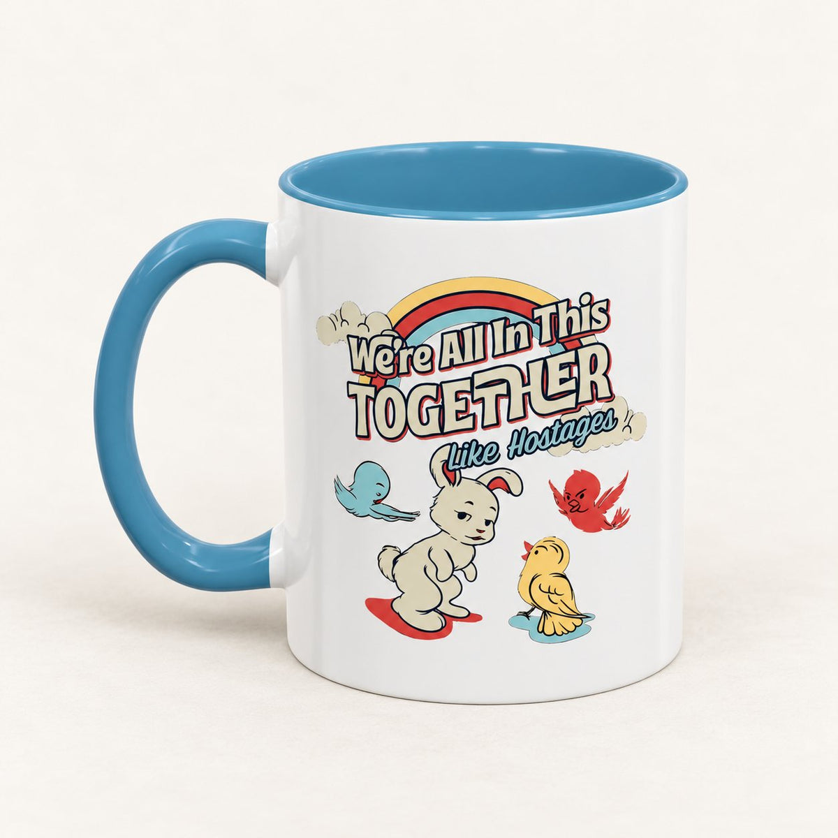 We’re All in This Together Like Hostages Coffee Mug on warm off-white background