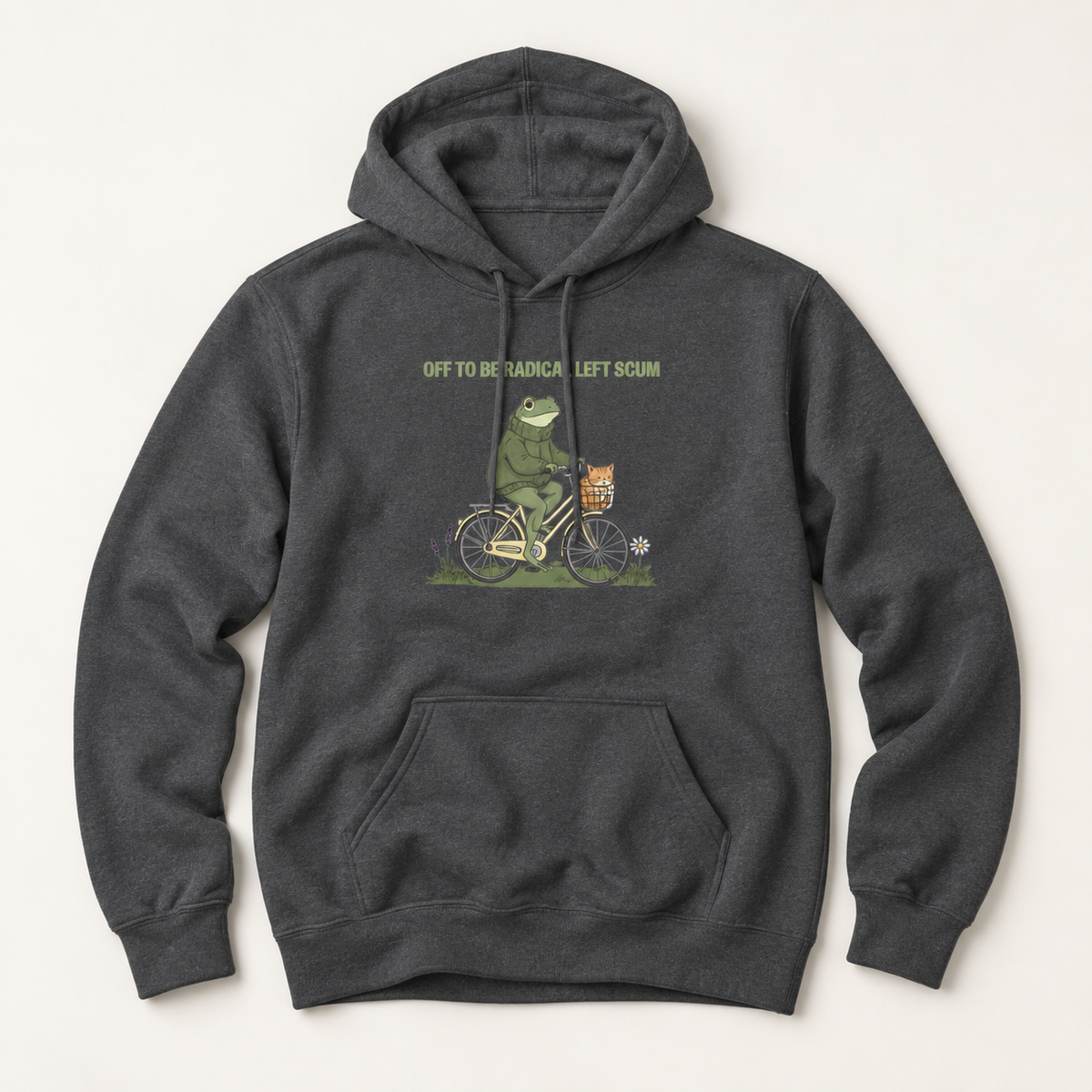 A dark heather gray pullover hoodie featuring a graphic of a green frog riding a bicycle with a basket, accompanied by the text 'OFF TO BE A TRAMPALE LEFT SCAM'.