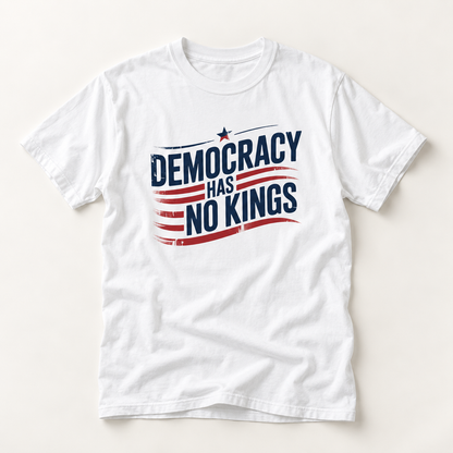 A white short-sleeve crewneck t-shirt with a distressed graphic on the chest that reads 'DEMOCRACY HAS NO KINGS' in navy blue text over red and navy stripes with a small star, displayed flat against a light beige background.
