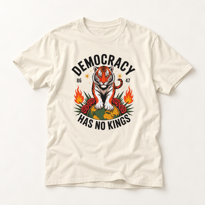 An off-white short-sleeve t-shirt with a graphic print of a tiger sitting on a globe, surrounded by flames and the text 'DEMOCRACY HAS NO KINGS' with the years '86' and '47'.