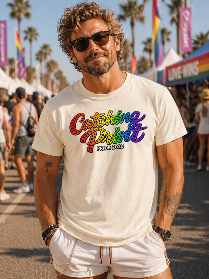 Man wearing a white t-shirt with colorful text at a Pride event.