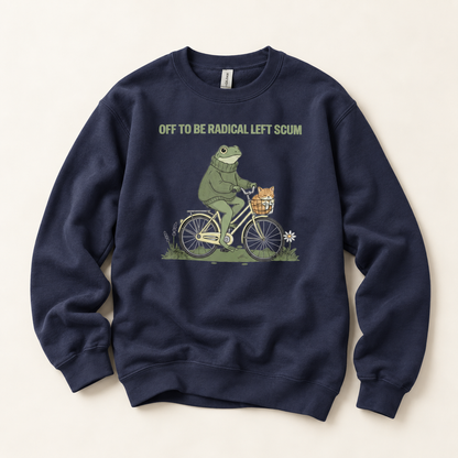 A navy blue crewneck sweatshirt featuring a graphic of a green frog riding a bicycle with a small orange cat in the basket, with the text 'OFF TO BE RADICAL LEFT SCUM' printed above. The sweatshirt is laid flat on a light beige background.