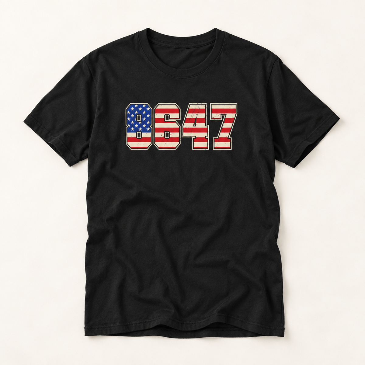 A black short-sleeve crewneck t-shirt featuring the number '8647' printed on the chest in an American flag pattern with red and white stripes and a blue field with white stars.