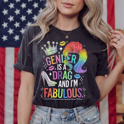 Person wearing a black t-shirt with colorful text and graphics in front of an American flag.
